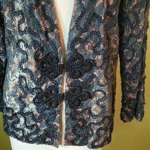 Formal wear top in black lace with copper tones.
